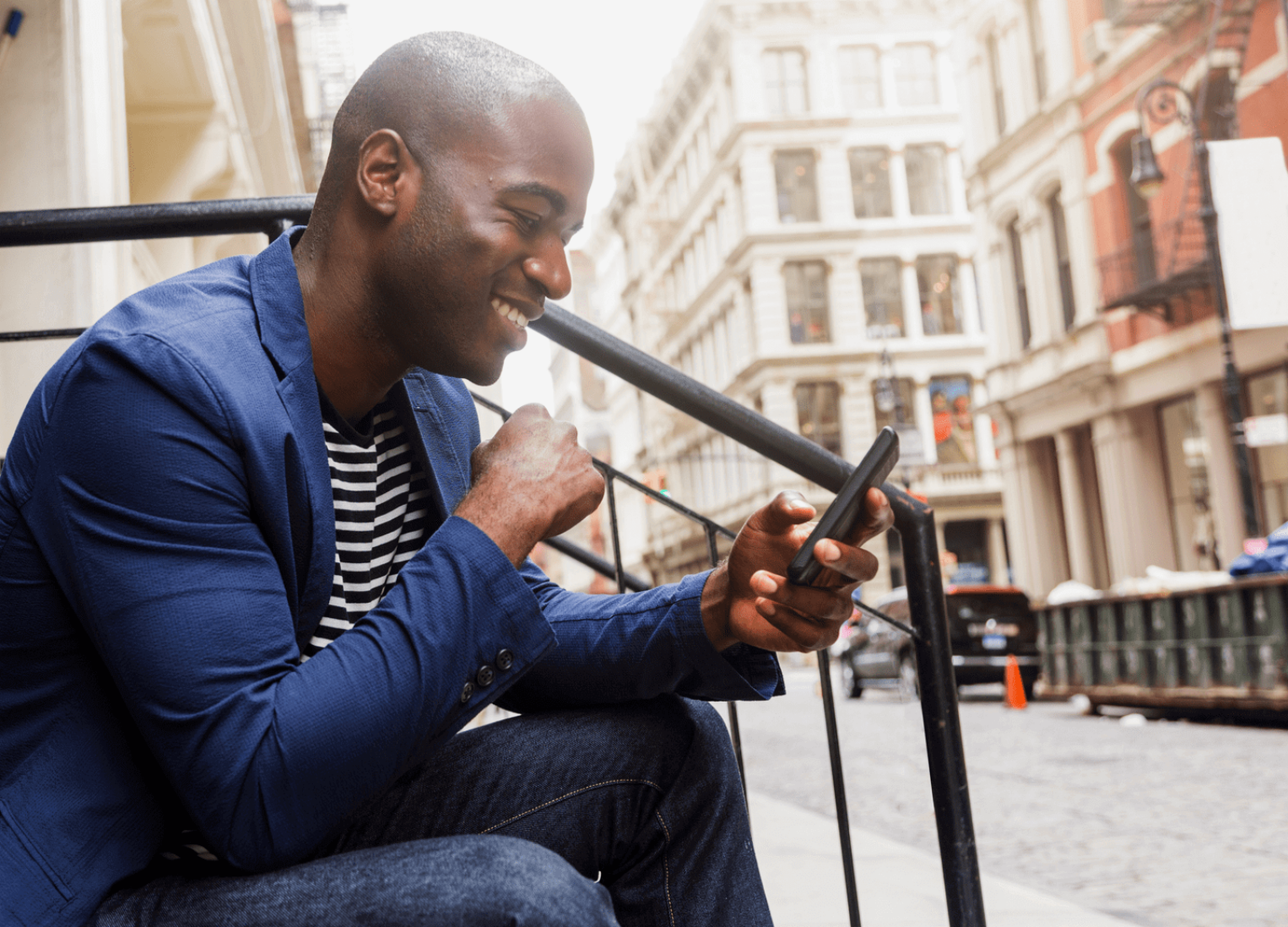 Man sitting outdoors using his phone.