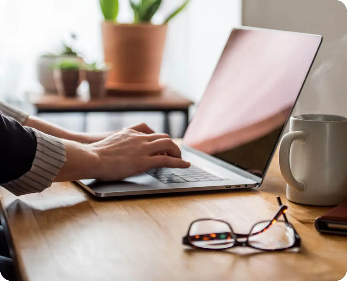 Close up shot of a man typing on a laptop.